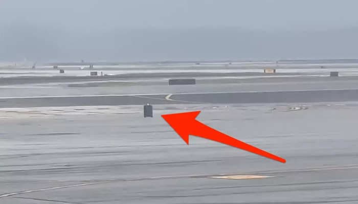 Video shows runaway luggage scooting across the tarmac at a windy San Francisco airport