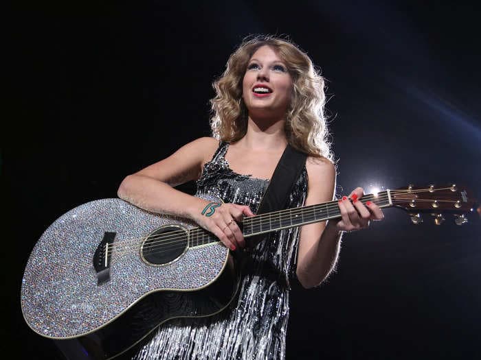 Taylor Swift's parents recreated her rhinestoned 'Fearless' guitar using super glue the day before the Eras Tour kicks off