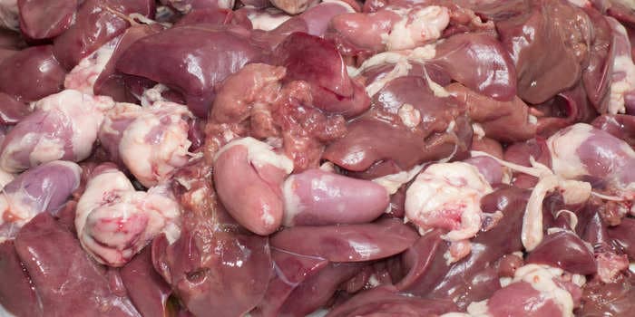 Gory scenes as a huge load of bloody animal organs and guts spilled onto a highway following a truck collision