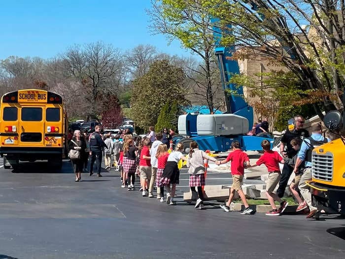 Heartbreaking video shows children holding hands as they're led to safety after a woman shot and killed 6 people at a Nashville elementary school