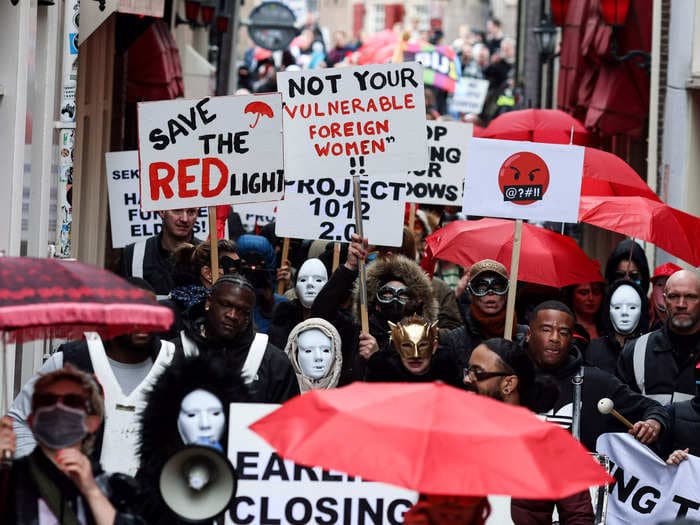 Sex workers in Amsterdam's iconic red light district are protesting new curfews and higher rents that would force them to stop working in windows