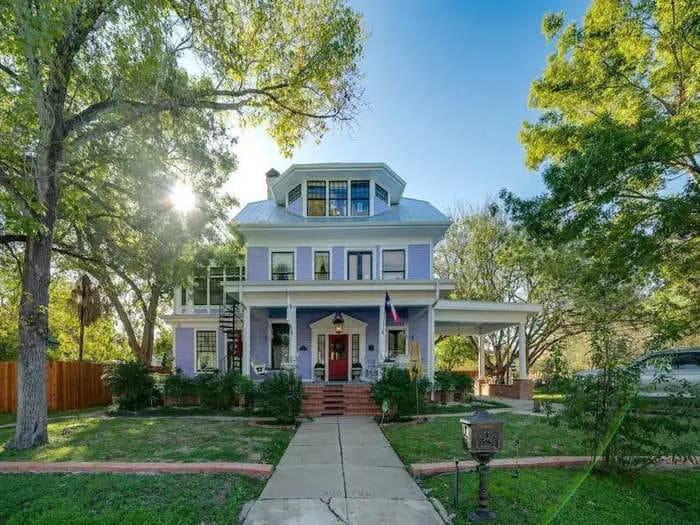 A Texas couple bought a neglected 110-year-old mansion and turned it into a maximalist paradise with rainbow-colored walls, thrifted artwork, and period furnishings