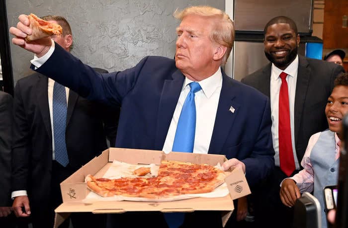 Trump offered pizza to supporters in a Florida restaurant, asking: 'Does anybody want a piece that I've eaten?'