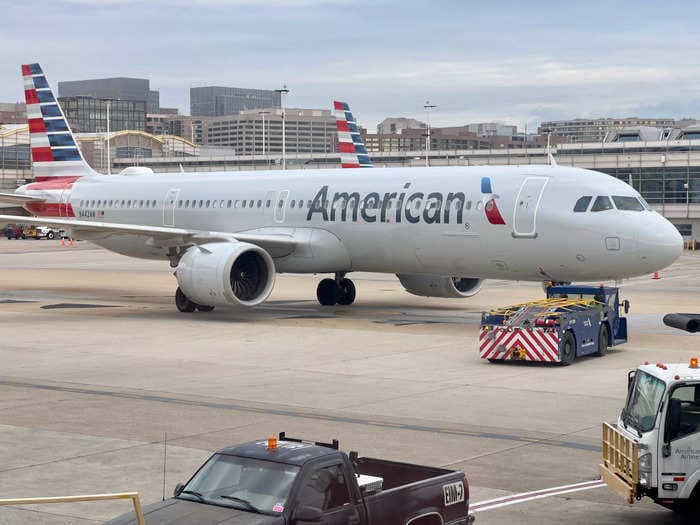 Video shows flames and smoke pouring out of the wing of an American Airlines plane just before takeoff