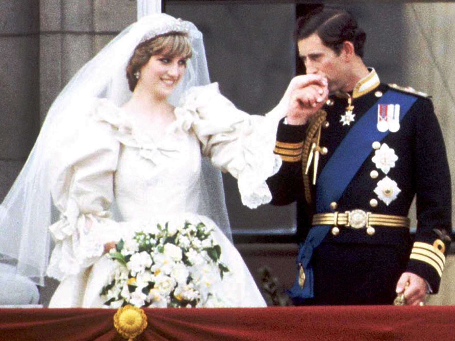 The newly wed Princess and Prince of Wales stand on the balcony of ...