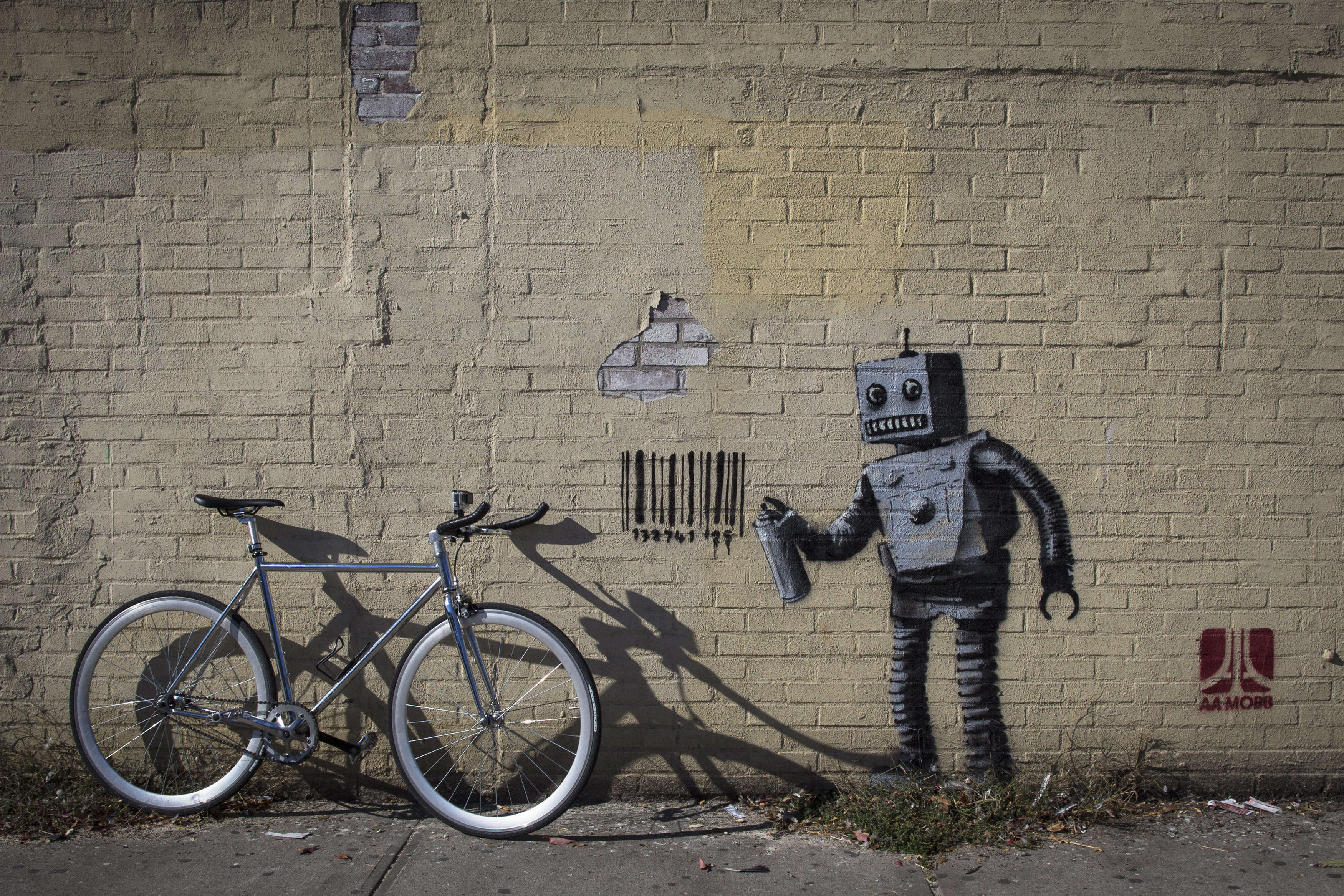 This robot graffiti artist tagging a wall with a barcode (what else ...