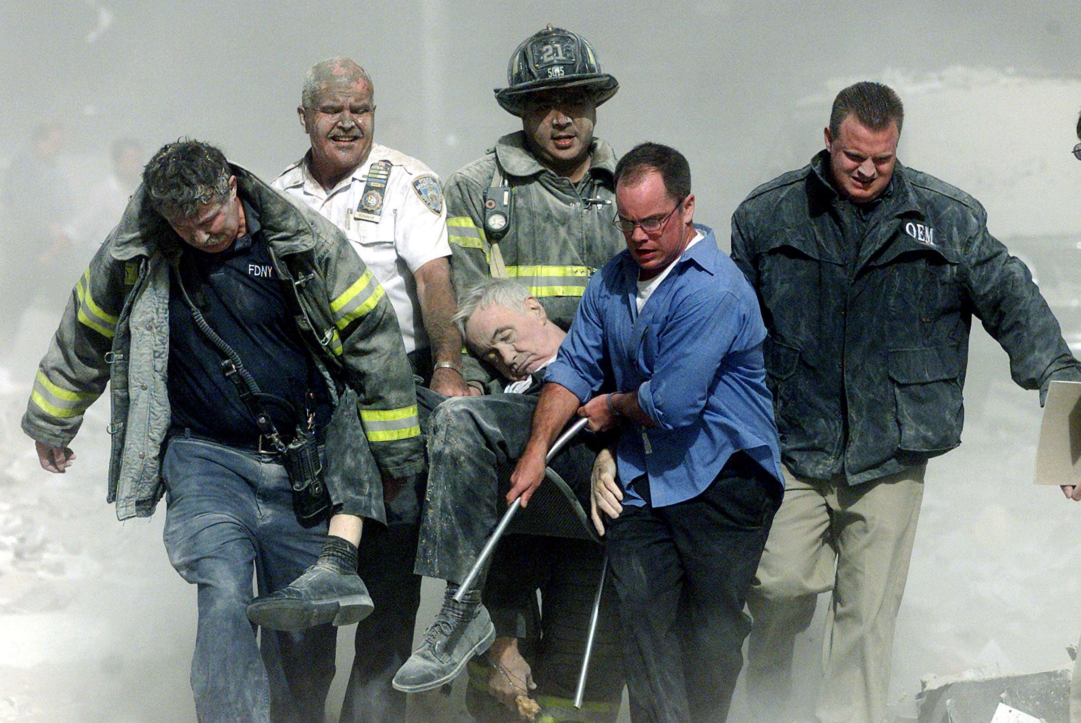Rescue Workers Carry Fatally Injured New York City Fire Department Chaplain Fether Mychal Judge