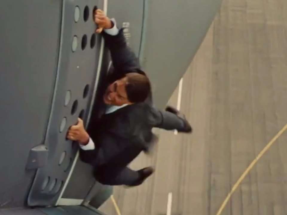 tom cruise hanging on to plane