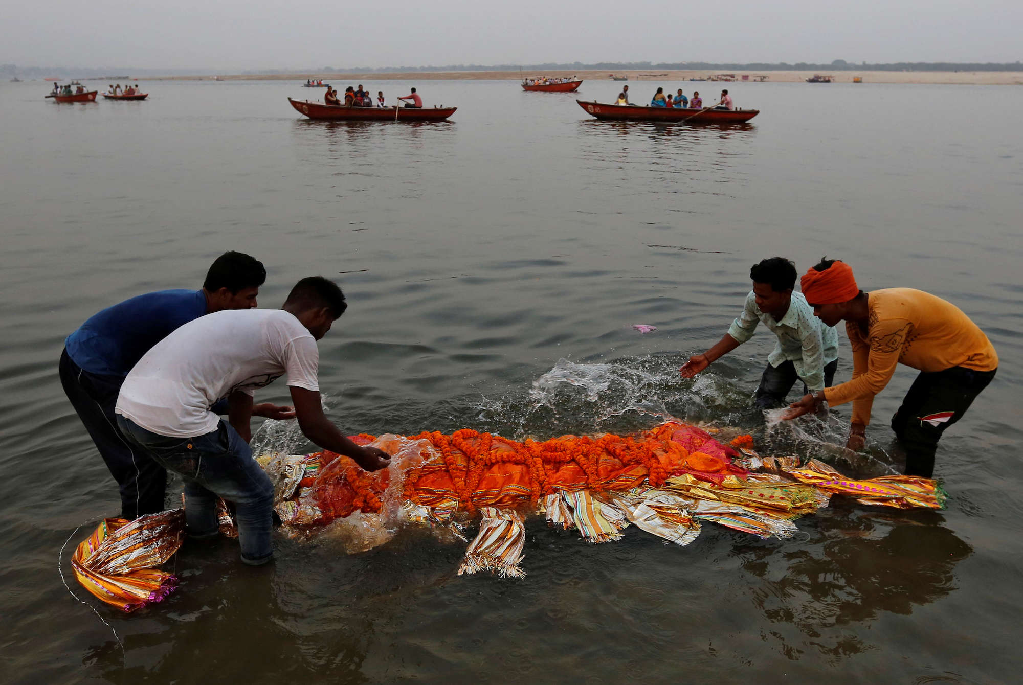 Devout Hindus Immerse The Bodies Of The Recently Deceased In The Holy   Devout Hindus Immerse The Bodies Of The Recently Deceased In The Holy River Water Prior To Cremation In Varanasi The Spiritual Capital Of India  