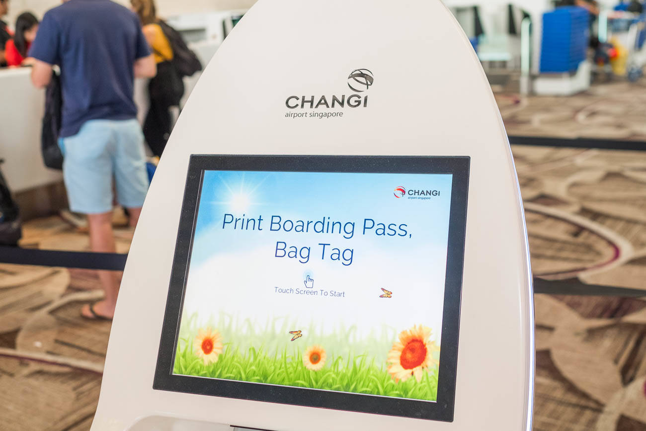 Singapore - Jun 27, 2017 : Flights Information Board And Machine At Changi  Airport Terminal 3.Young Girl With Her Mother Touching Self Check In Kiosks  Interactive Screen To Check In Online. Stock