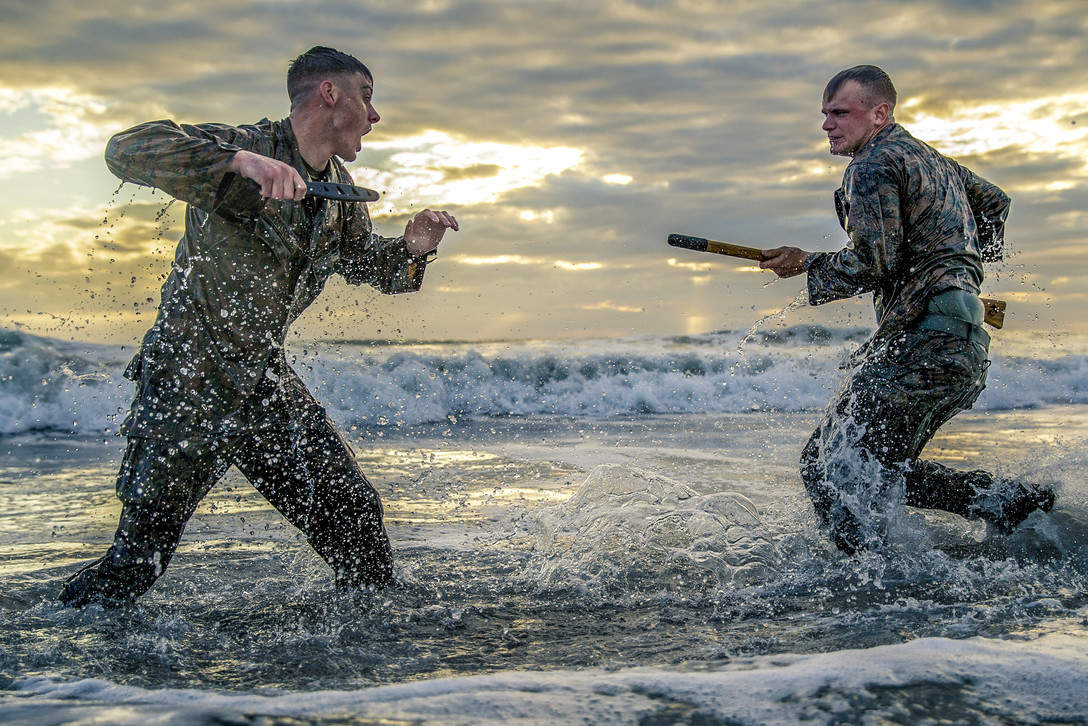 Marine Corps Cpls. Matthew Teutsch and Brett Norman participate in hand