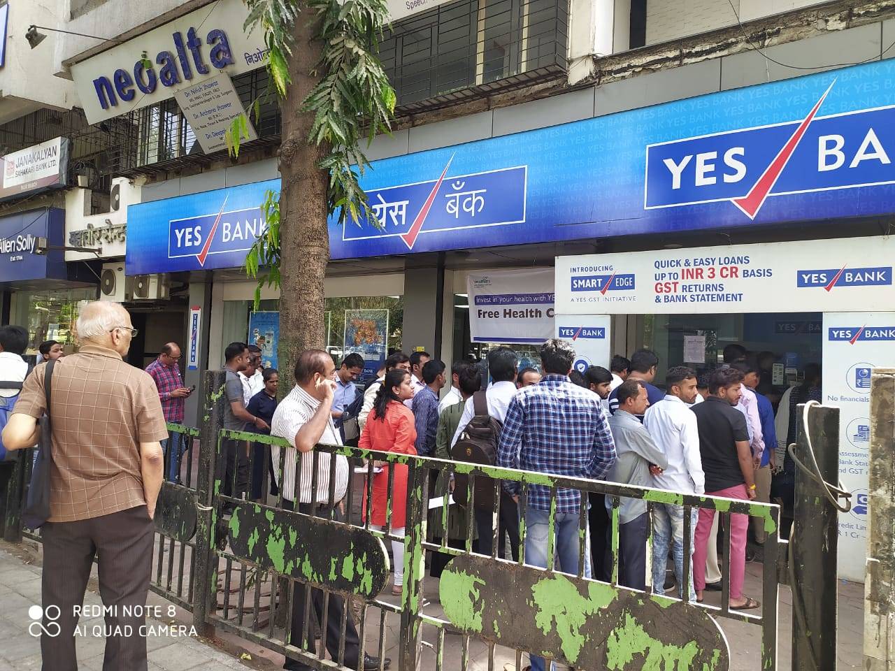 In pics: Customers of Yes Bank line up outside ATMs for cash fearing