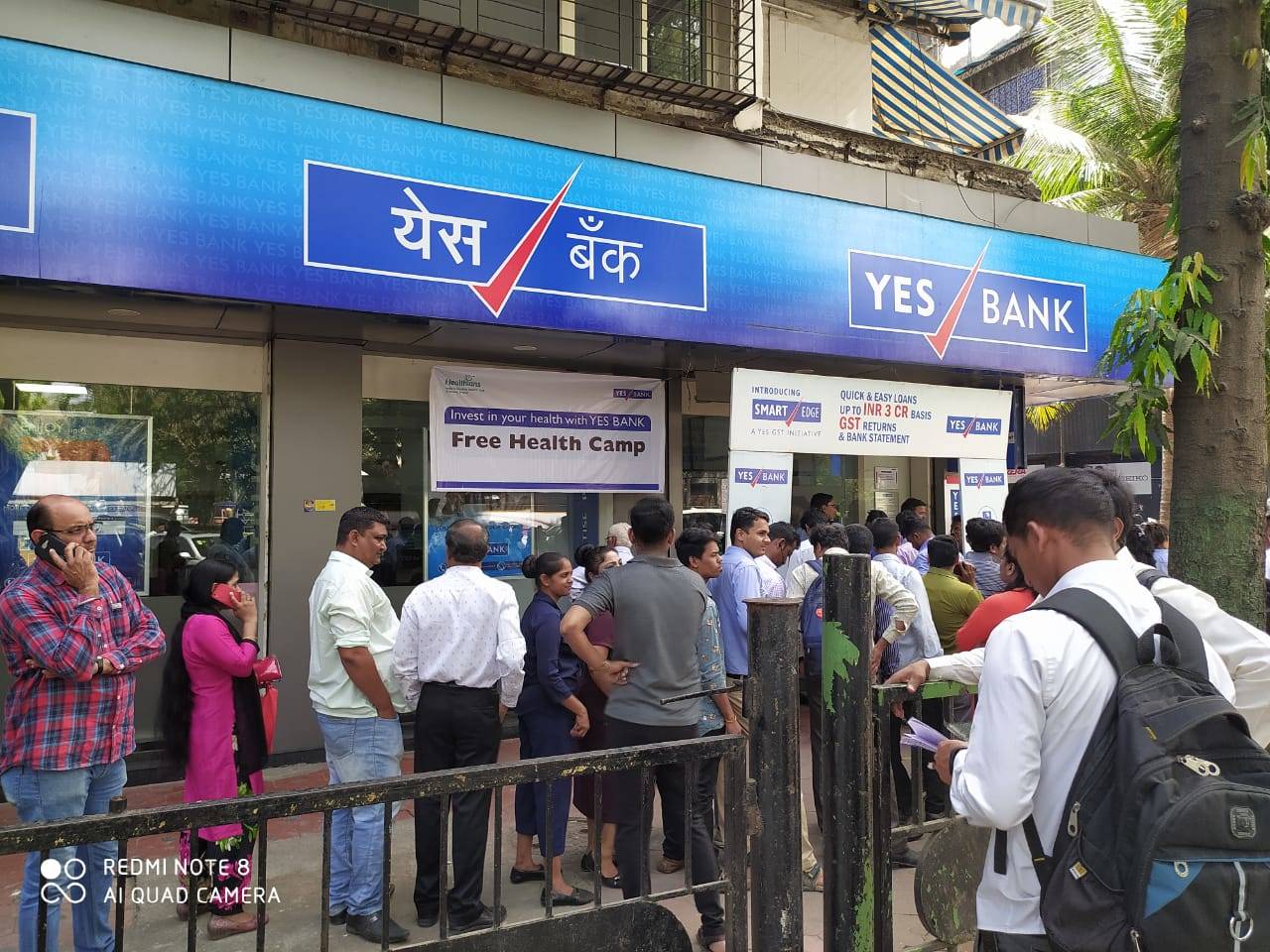 In pics: Customers of Yes Bank line up outside ATMs for cash fearing loss  of deposits