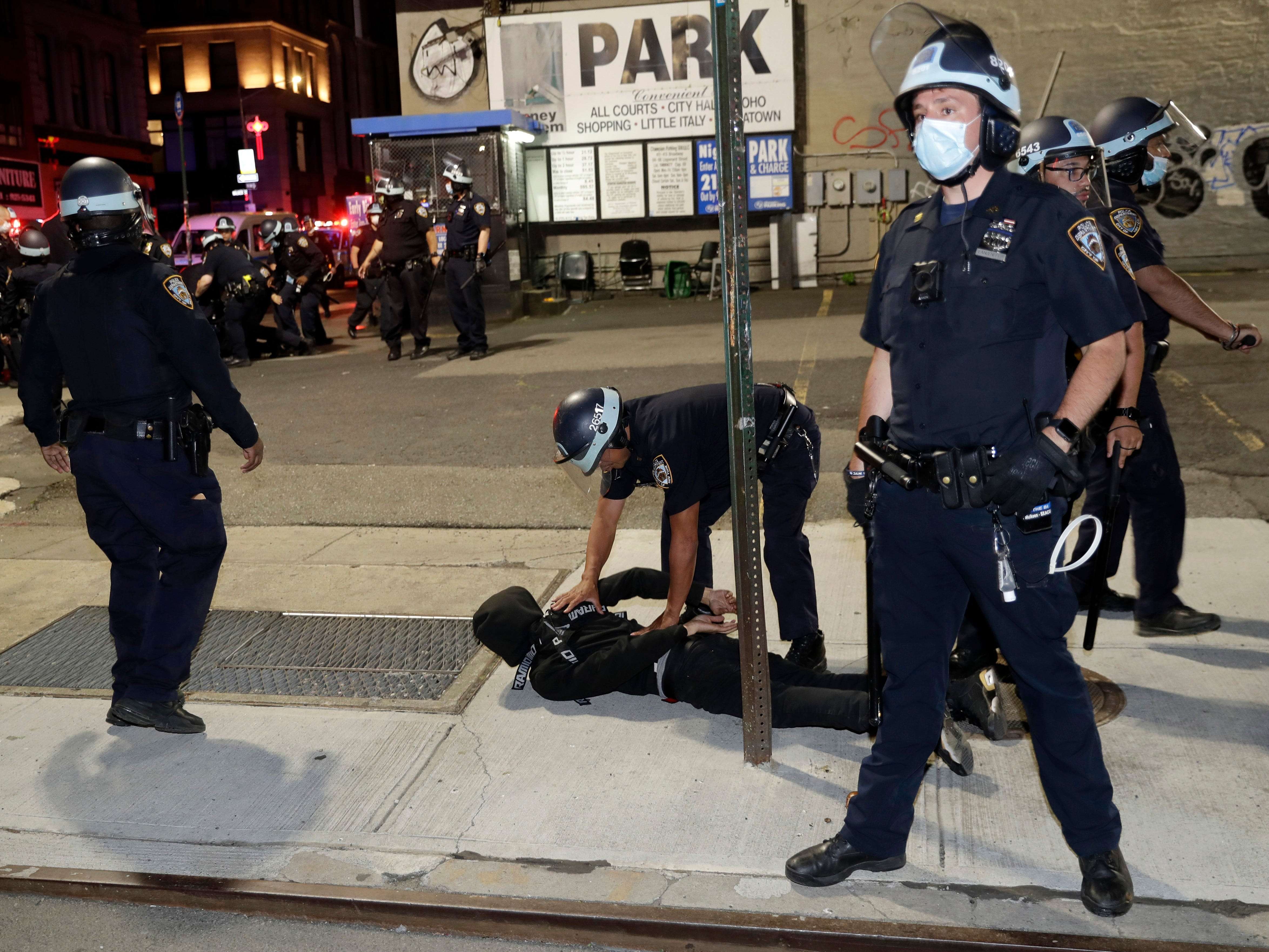 A New York police officer drew his gun on protesters. Mayor Bill de ...