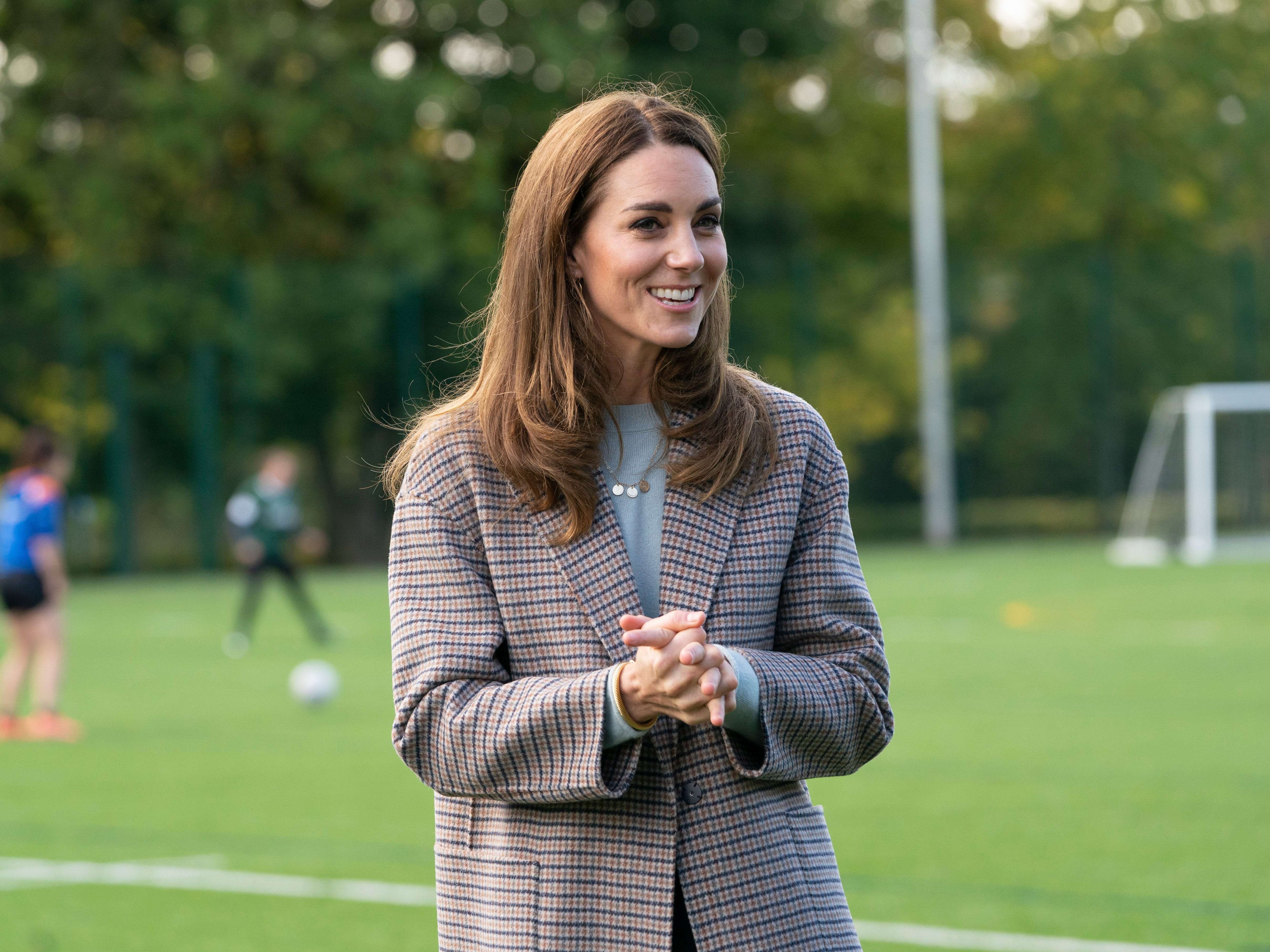 Kate Middleton layered a $349 checkered coat over a light-blue sweater ...