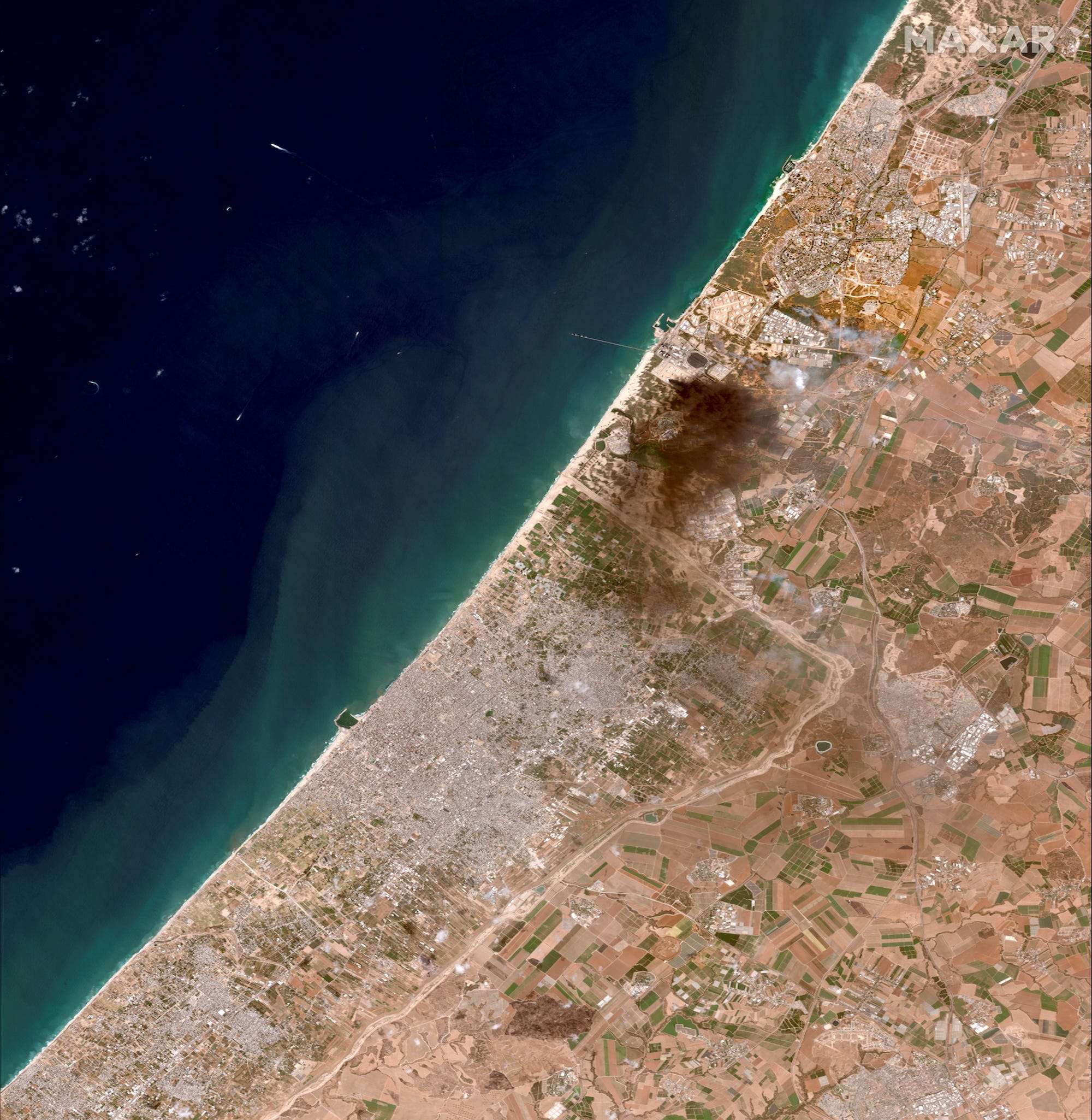 Satellite photos show leveled buildings and plumes of smoke in Gaza