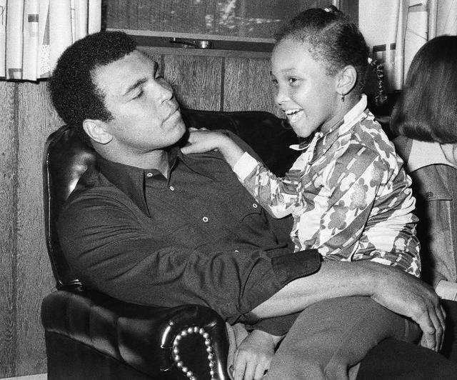 A fighter and a family man: Muhammad Ali cuddles up to his seven-year ...